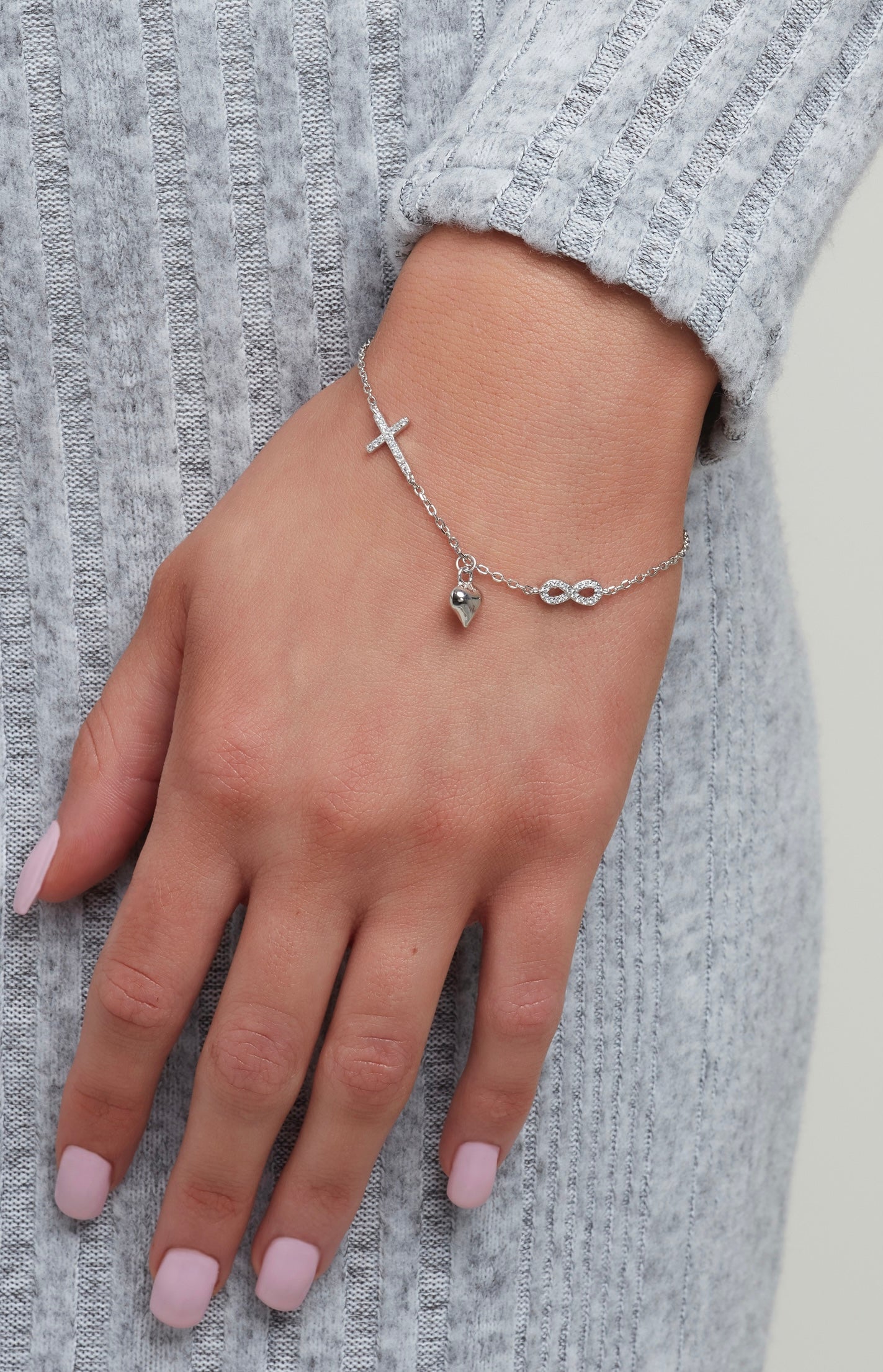 Sparkle By Princess Andre: Sterling Silver Adjustable Charm Bracelet featuring a Cross, Heart and Infinity Symbol with CZ Simulated Diamonds